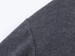 Macro shot of dark grey twill knit fabric with reinforced shoulder seam detail