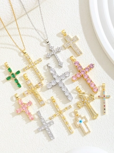 Macro display of diverse cross pendants with colorful cubic zirconia and gold plating
