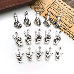 Macro shot of 15 pieces silver gesture pendants including OK, peace and ILY hand signs