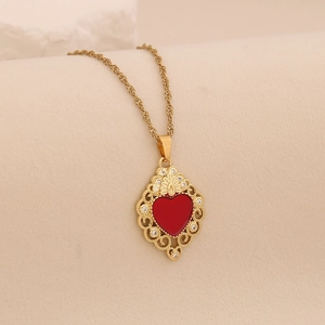 Detail of gold filigree pendant necklace featuring a red heart zircon and micro-pave crystals