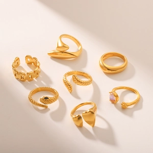 Set of 7 gold-plated stainless steel rings with heart, snake, and geometric textures