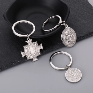 Detailed macro of silver stainless steel religious pendants with Saint Benedict engraving