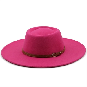 Detail of rose red wool fedora hat featuring a brown leather belt buckle strap accessory