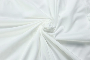 Detail view of pure white pleated fabric showing soft texture and elegant drape of the dress