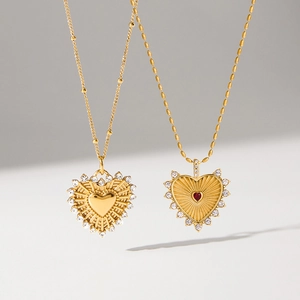 Gold-plated heart pendant necklaces with sparkling crystals and red gemstone inlay