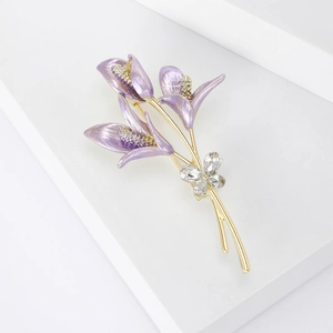 Close-up of lavender enamel flower brooch with gold stem and marquise crystals