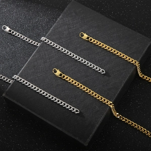 Detailed close-up of gold and silver cuban link chains displayed on a black jewelry case