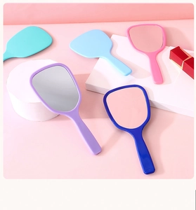 Set of pastel handheld makeup mirrors in purple, blue, pink and cyan on geometric props