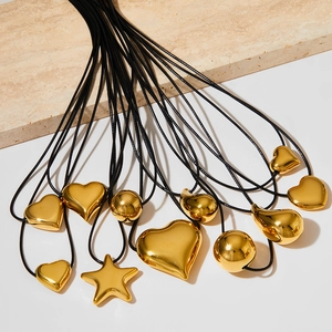 Minimalist gold heart and star pendants on black wax cords for fashion accessories
