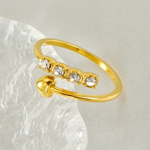 Polished 18K gold plated heart ring with sparkling zircons on elegant silk background
