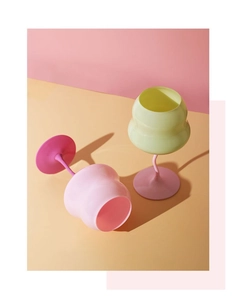 Close-up of vibrant macaron colored crystal wine glasses with unique twisted stems