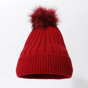 Classic dark red knit beanie hat with matching large pom-pom and thick ribbed texture