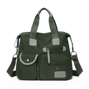 Deep green nylon travel bag with multiple pockets and adjustable shoulder strap