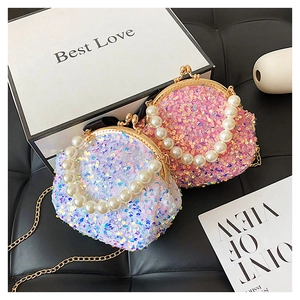 Close-up of pink and iridescent sequin mini shell bags with pearl handles and gold chains