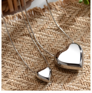 Detail of two 3D heart pendants in small and large sizes on elegant snake chains