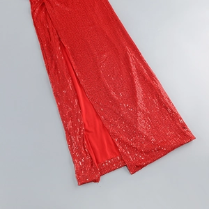 Detailed view of red sequin fabric texture and high slit cut on a formal evening gown