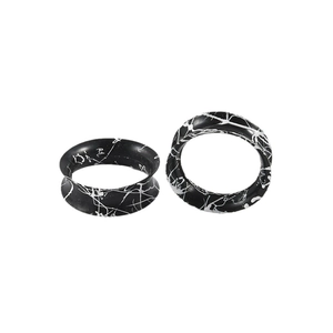 Pair of black hollow silicone ear gauges with white marble texture and flared design