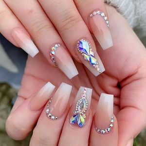 Close-up of pink and white gradient long coffin nails with sparkling rhinestones