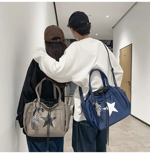 Detailed view of gray and navy water-resistant drawstring tote bags with star patterns