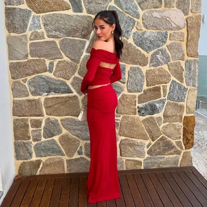 Detail of red two-piece set featuring off-shoulder long sleeves and open back design