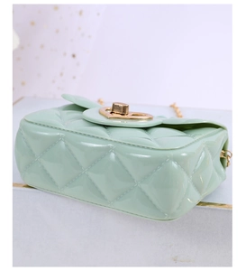 Detail of mint green jelly bag with quilted pattern and golden heart-shaped twist lock