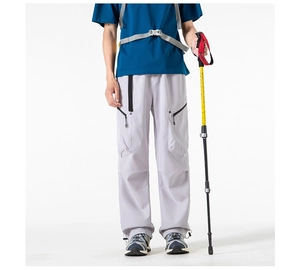 Detail view of water-resistant cargo pants with multiple pockets and drawstring hem