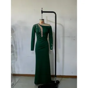 Detail of emerald green evening dress featuring sequin cut-out neckline and rhinestone trim