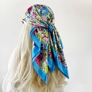 Detailed back view of a woman wearing a satin square scarf with cartoon cat prints
