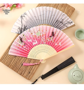 Detail of traditional Chinese folding fans with cherry blossom and crane embroidery patterns