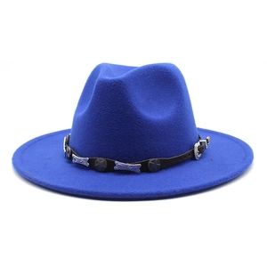 Close-up of royal blue fedora hat featuring a black leather band with silver star studs