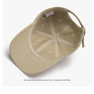 Detailed interior of a khaki cotton baseball cap showing reinforced seams and care label