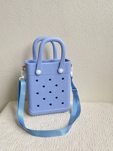 Detail view of lavender EVA tote bag featuring classic perforated design and long strap