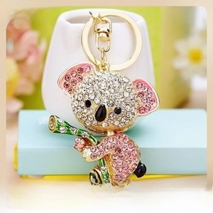 Detail of sparkling rhinestone koala keychain with green bamboo leaf and golden ring