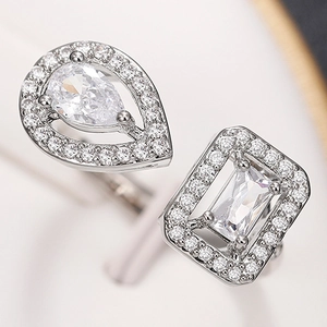 Detailed macro view of pear-cut and rectangular zircon stones on a silver open ring band