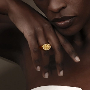 Close-up of 18K gold plated stainless steel signet ring with micro-set zircon flowers