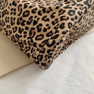 Macro shot of durable leopard print canvas bag corner showcasing reinforced stitching