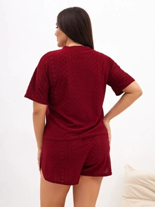 Close-up of wine red two-piece pajama set featuring laser-cut diamond pattern details