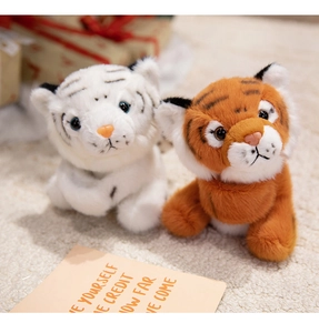 Close-up of cute white and brown tiger plush bracelets on a soft beige carpet
