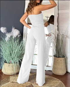 Close-up of white strapless jumpsuit showing back zipper and high-waist wide-leg detail