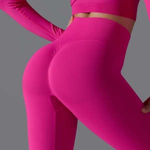 Detail of high waist hot pink seamless yoga pants showing scrunch butt and knit texture