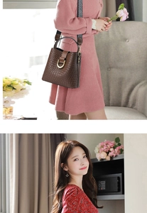 Brown textured bucket bag with wide geometric strap and gold hardware detail