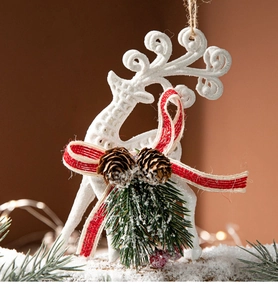 Christmas reindeer hanging ornament with pine cones, needles, berries and a red bow