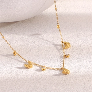 Detailed close-up of 18K gold plated butterfly pendant with zircon stone on bead chain