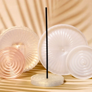 Detailed view of round silicone resin molds for creating decorative incense trays and coasters