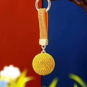 Sparkling yellow rhinestone ball keychain with gold metal ring and crystal tassel