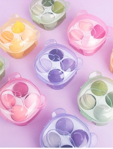 Macro view of cute bear-shaped storage boxes holding four colorful makeup sponges each
