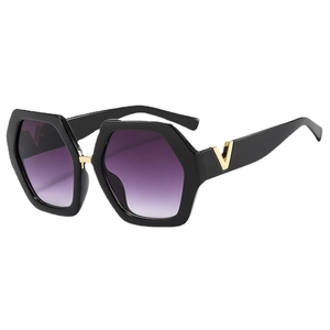 Stylish oversized hexagonal black sunglasses with purple gradient lenses and gold V detail