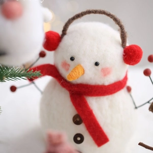 Handmade wool felt Christmas snowman with red earmuffs and scarf for festive decoration