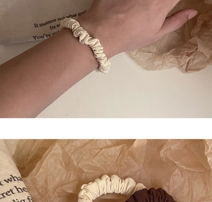 Close-up of pleated scrunchies showing fine fabric texture and elegant ruffled details