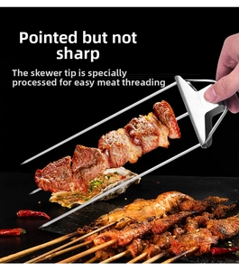 Detail of 3-prong stainless steel BBQ skewer with slider for meat release